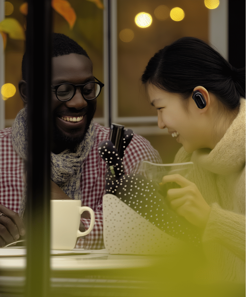 Happy couple using AI earbuds at a café
